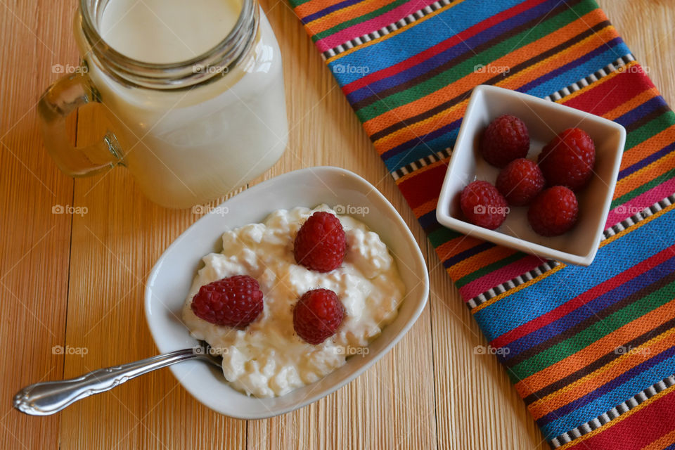 Cold glass of milk with fruit and cottage cheese