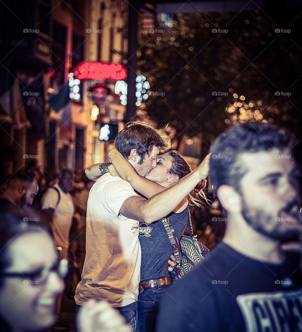Couple kissing in crowd