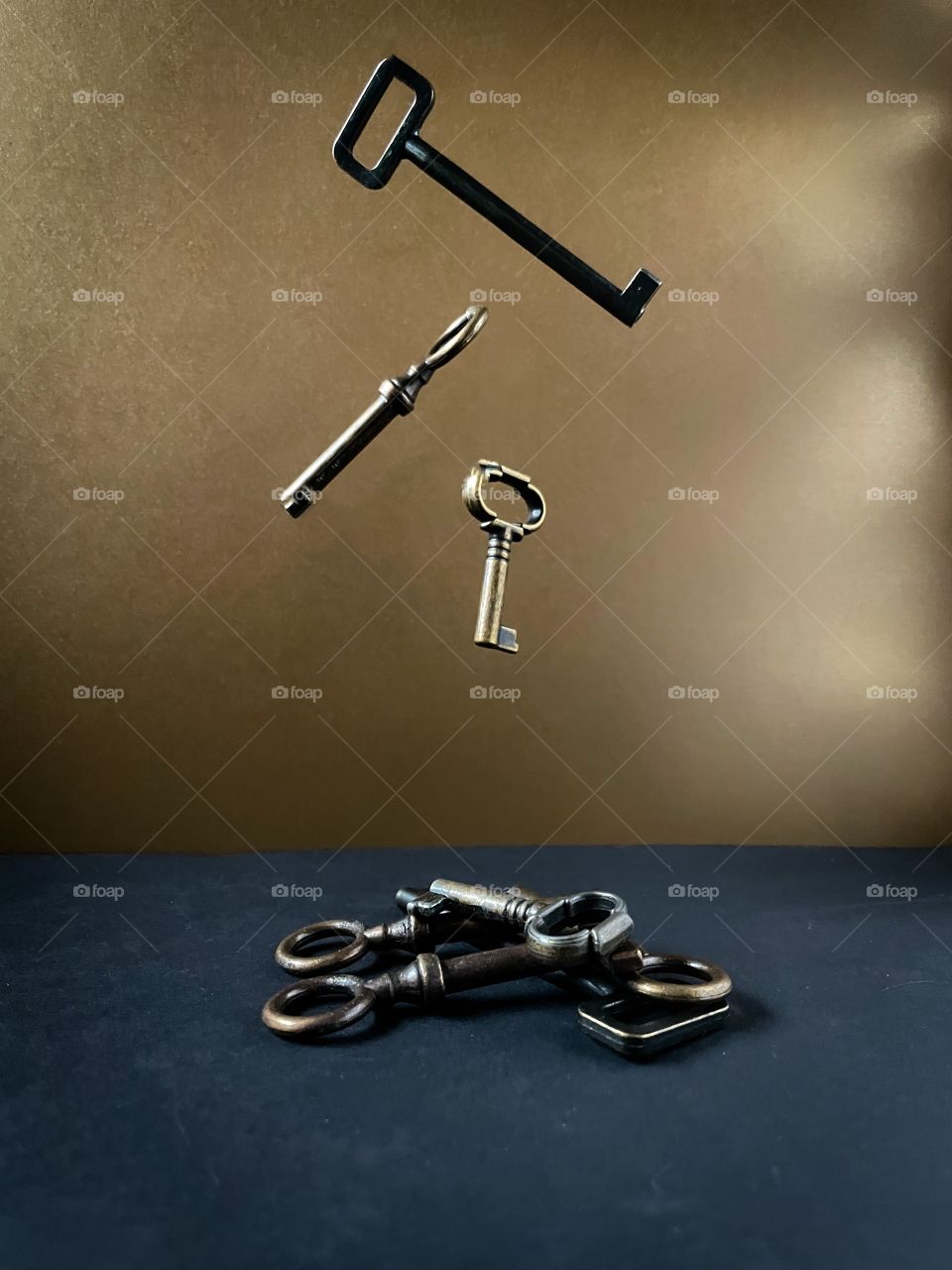 Black, brass, and gold keys falling into a pile of interesting keys. 
