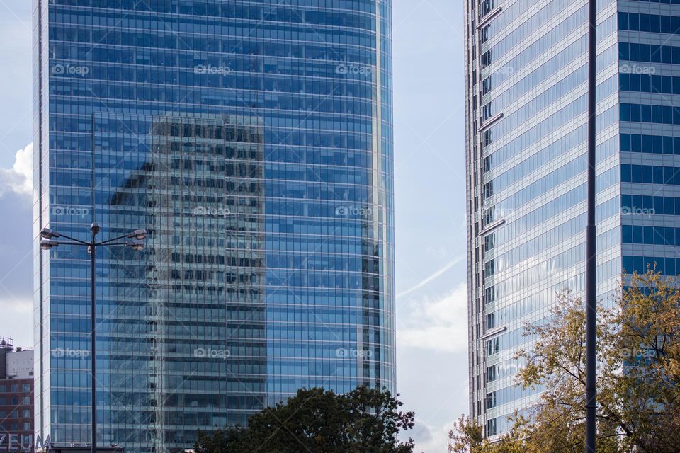 reflection of the neighboring skyscraper in the windows