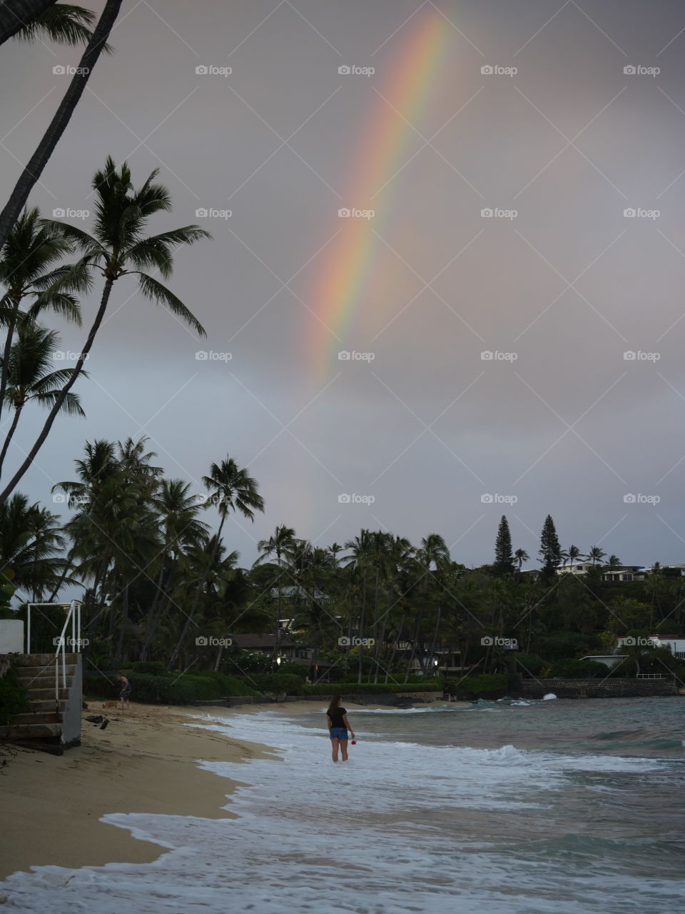 Rainbow from the clouds above the beach