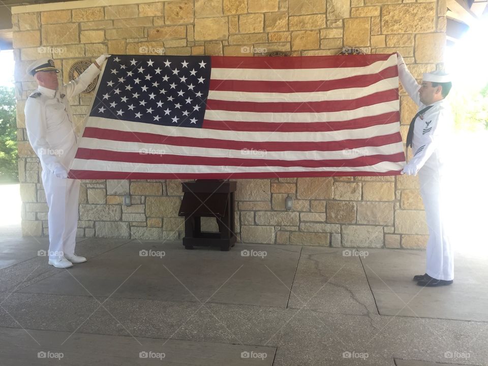 A large American flag at a military funeral