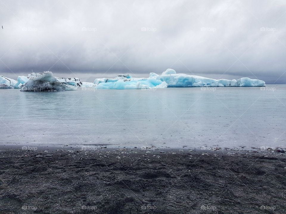 Icebergs close to a black sand Beach