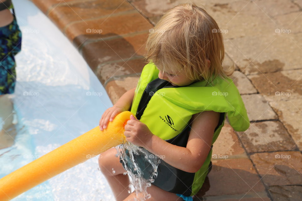 water fun. cousin playing in the pool, taken in Toronto