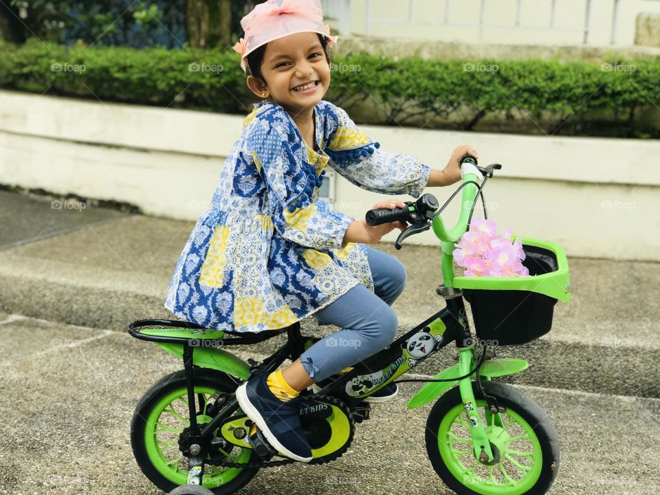 Cheerful smile of baby girl while cycling 😊