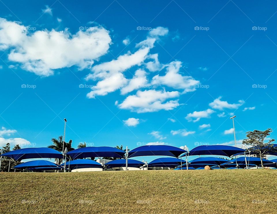 Multiverse: Blue Awnings multiply in the parking lot.