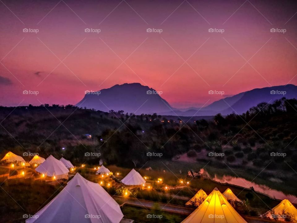 The sunset view from my tent while camping in Chiang Dao, Thailand.