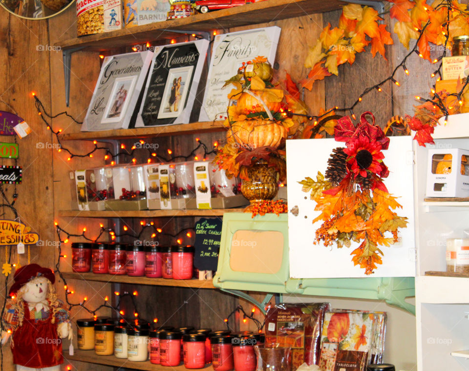 Candles and fall decorations on shelves at a country farm market