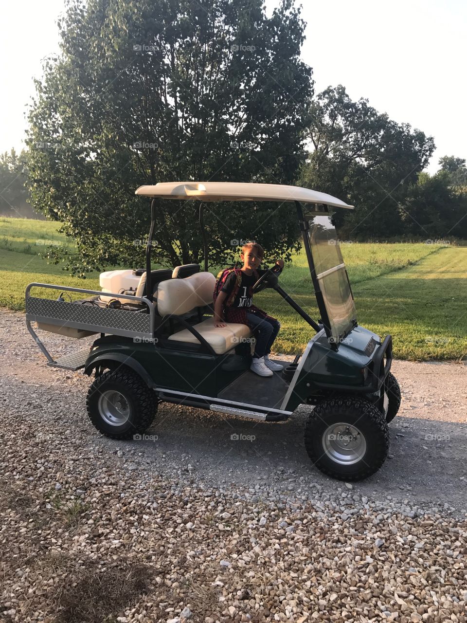 Boy in golf cart