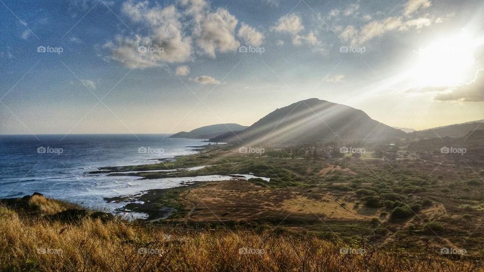 A ray of sun shining over the mountain.