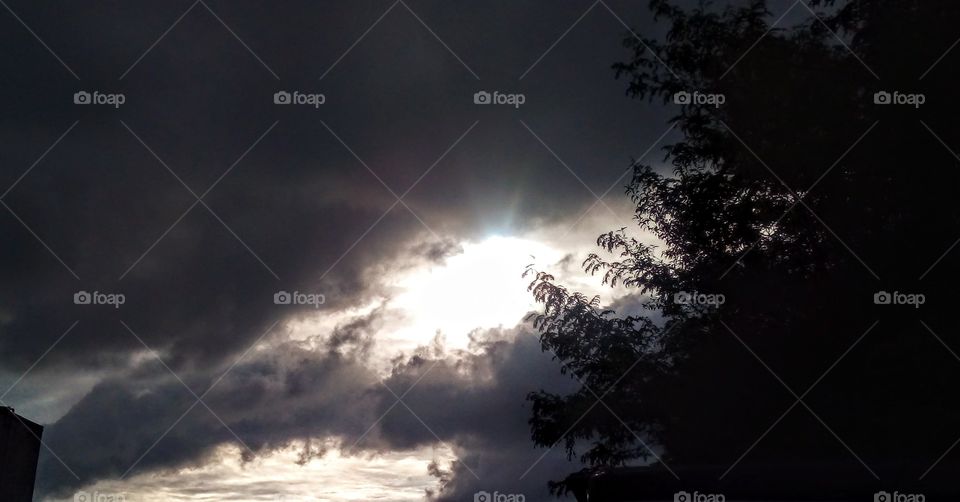 ominous clouds broken by sunbeam