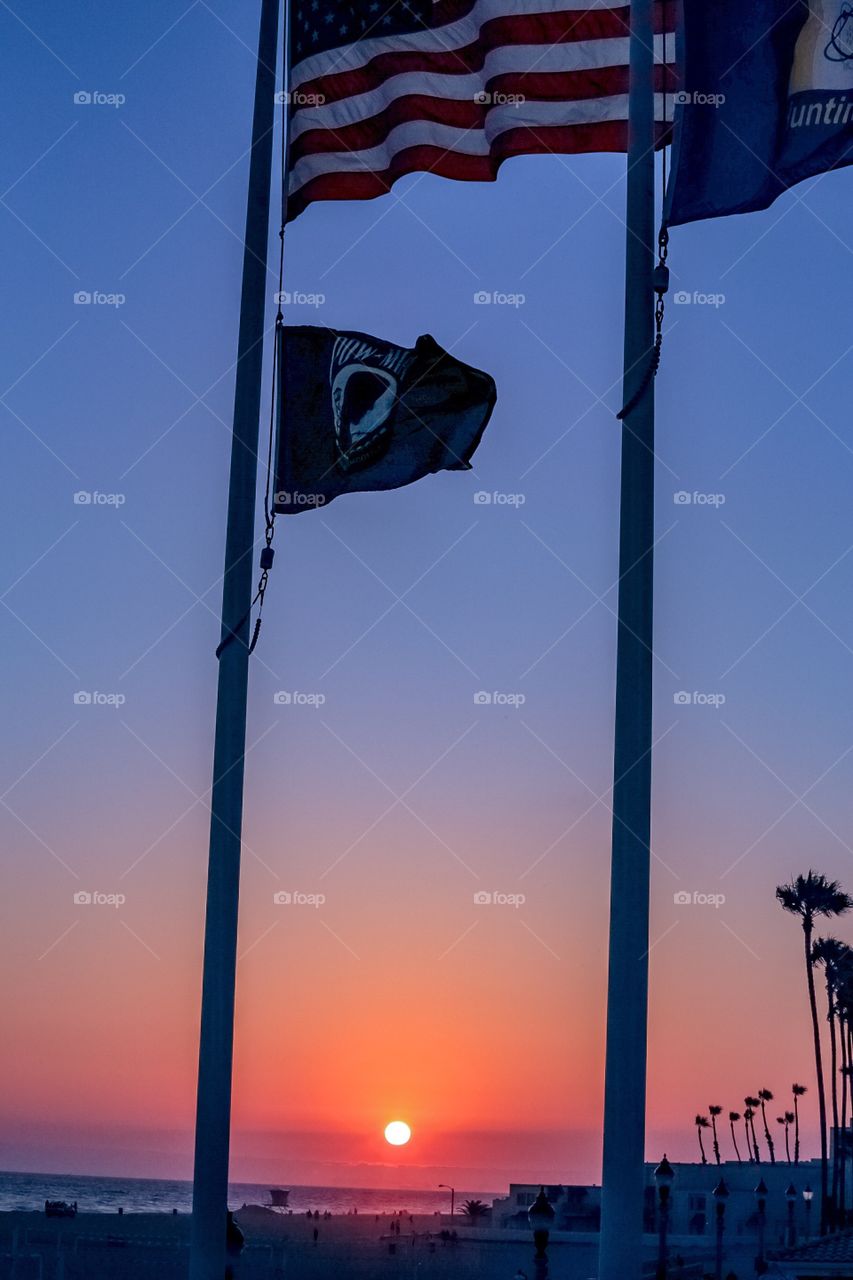 HB pier flags at sunset 