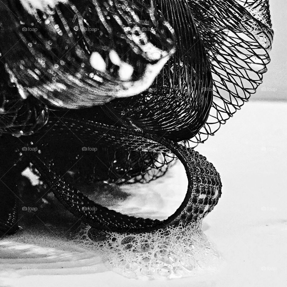 A black scrubby on a white soapy background!