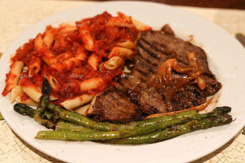 Penne with homemade marinara sauce, steamed asparagus and grilled korean steak with onions