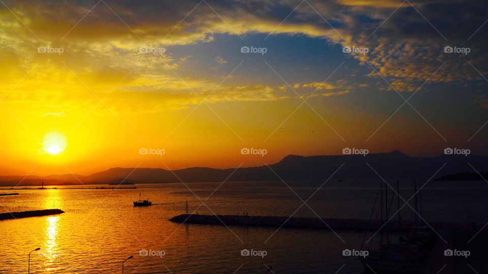 Deep sunset over Corfu Town Old Harbour, Greece