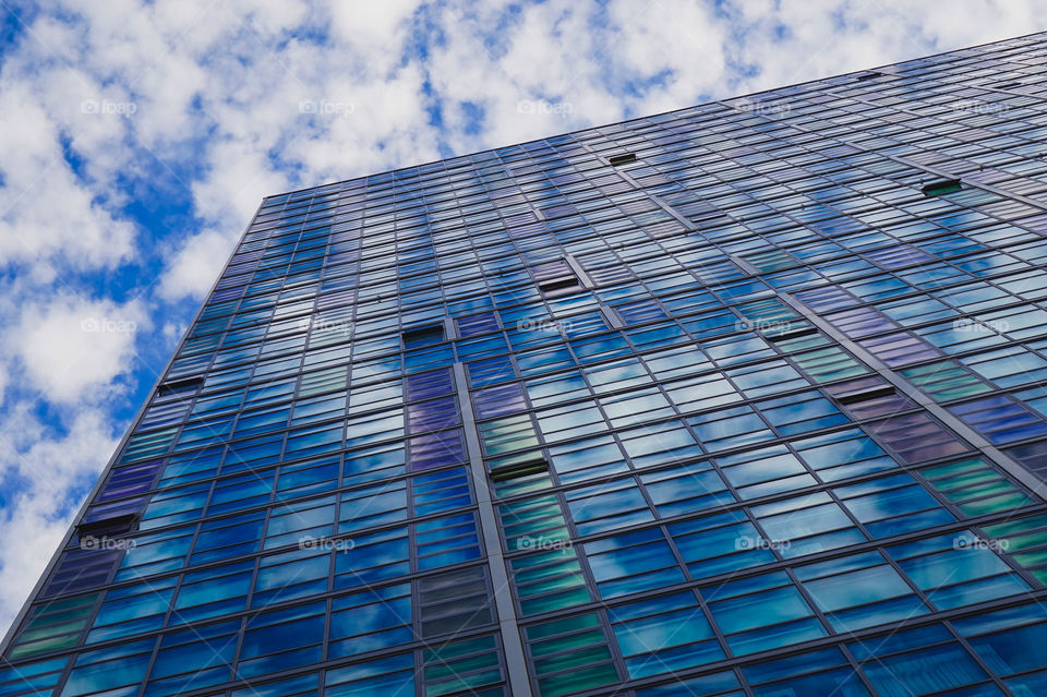 Colorful windows reflecting a cloudy sky in Southbank, Melbourne, Australia 