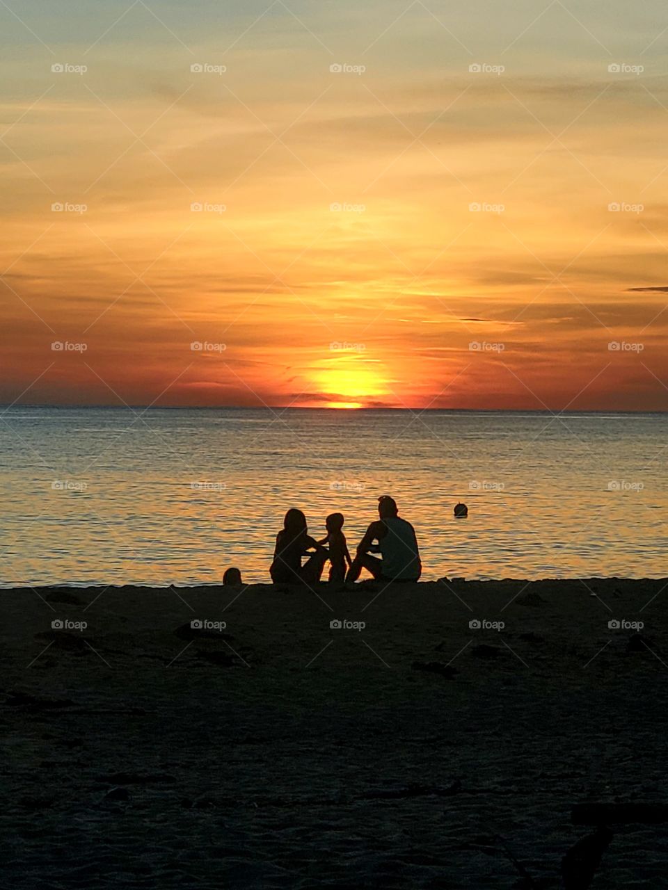 Family enjoying a sunset at the beach