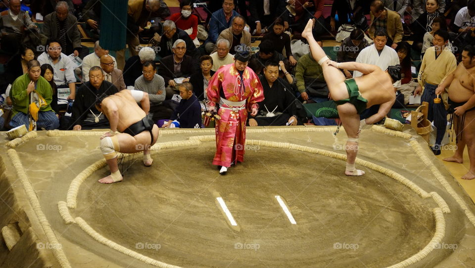 Sumo wrestlers making preparations for their bout
