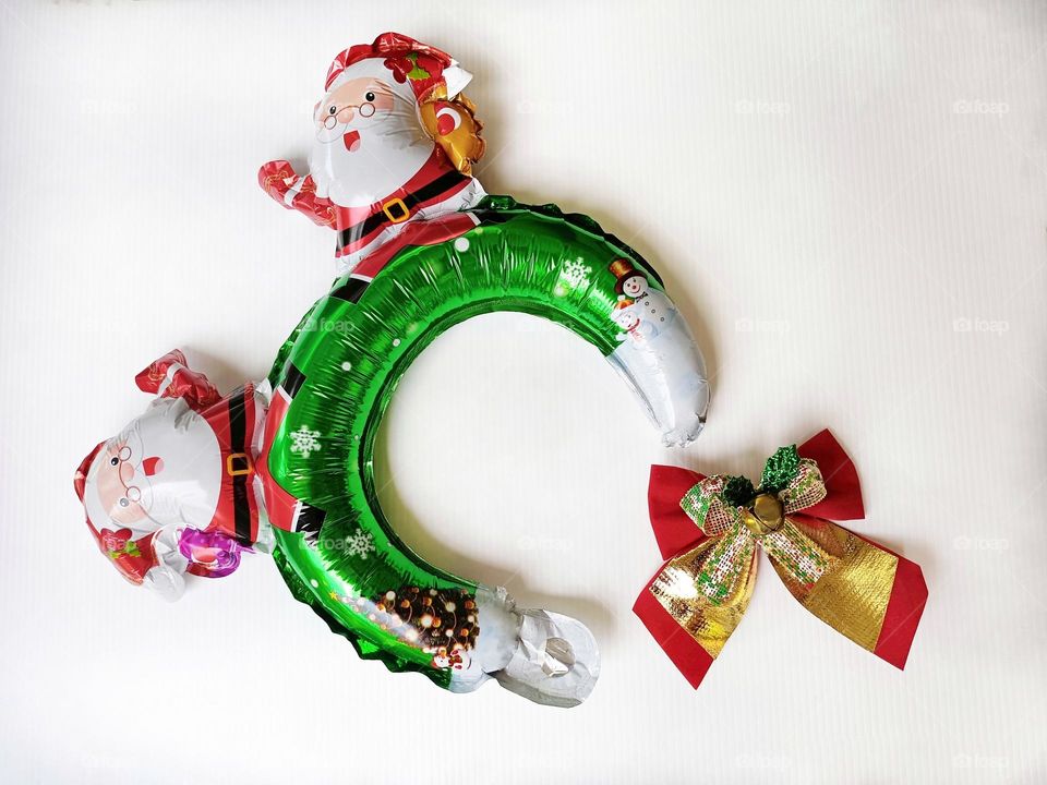 Santa Claus Christmas headband and Christmas bow on white background horizontal composition.