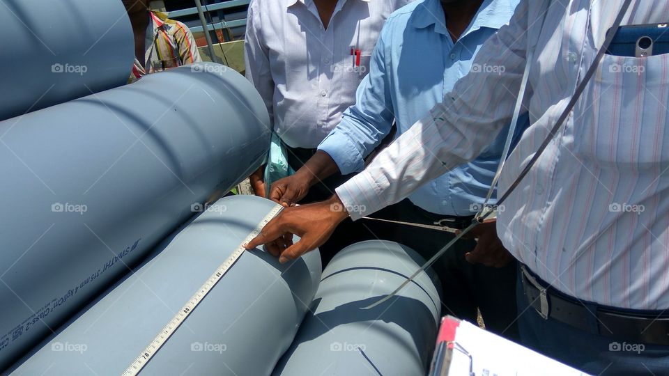 people's working in hands they're doing measurements pipeline