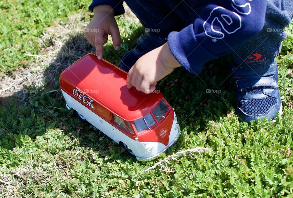 Child playing with old school VW Coke bus