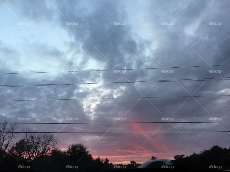 Sun setting behind the clouds