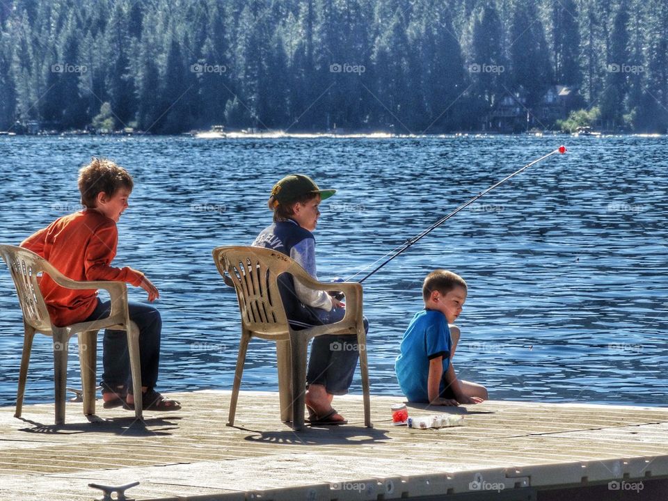 Young Fishermen At A Mountain Lake. Boys Fishing On A Lake
