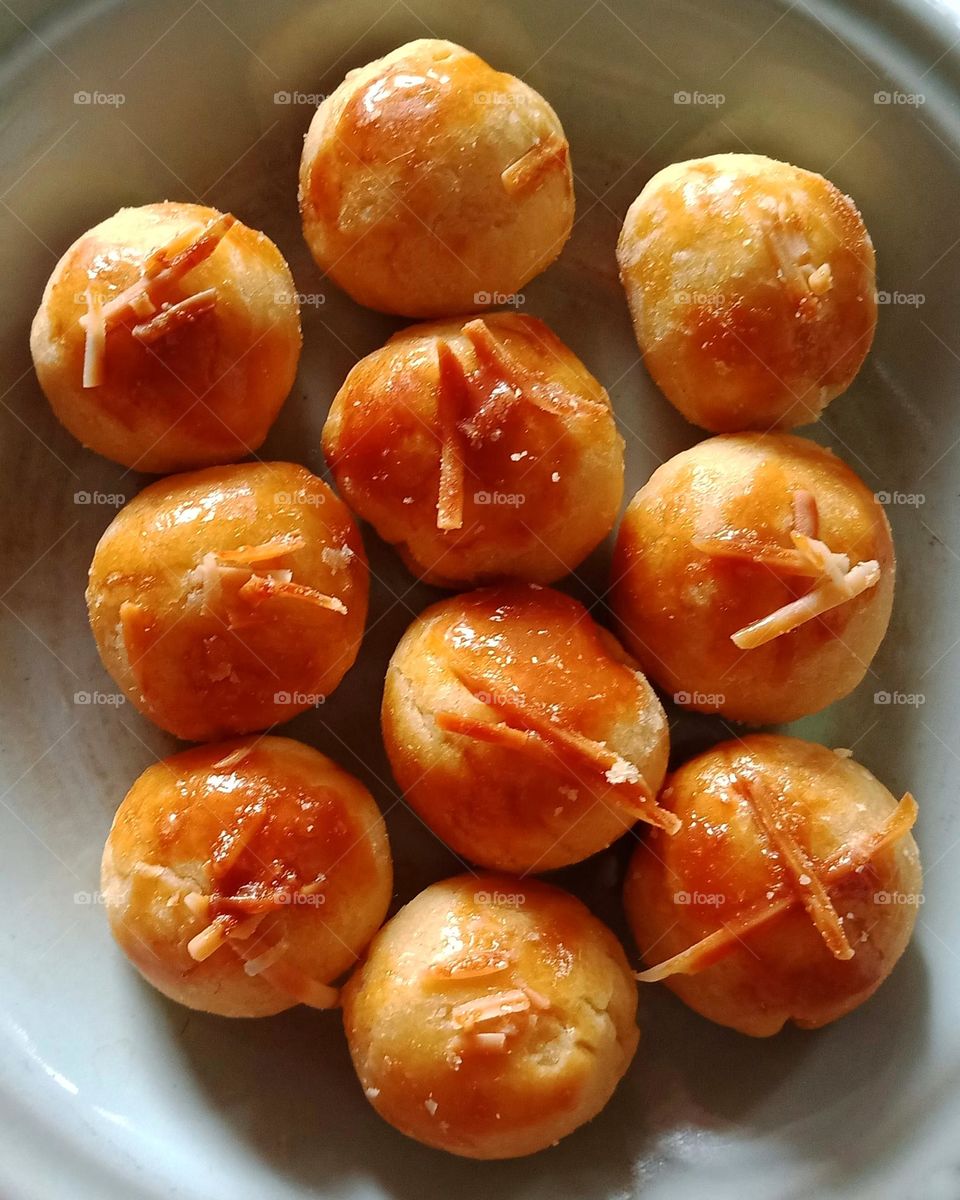 Delicious yellow cookies on plate