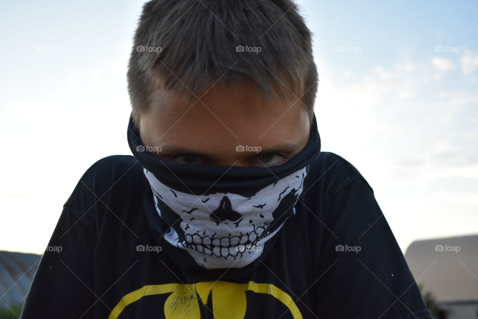 Boy wearing skull bandana and black shirt 