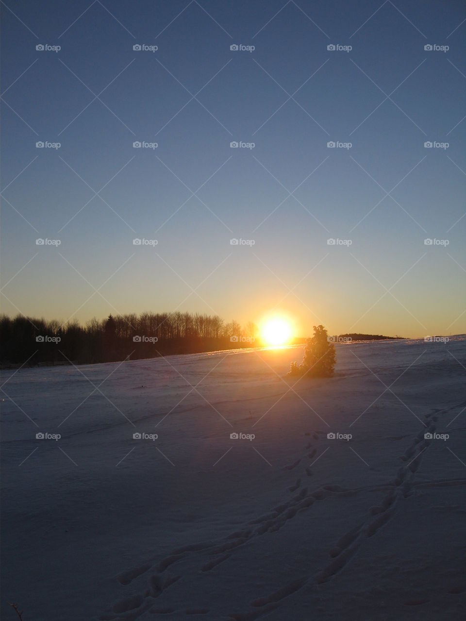 sunset accross hill with snow