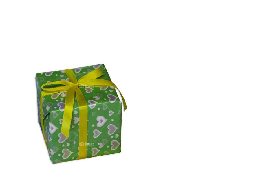 Isolated Gift box wrapped with heart pattern for the festivities on a white background with clipping path.