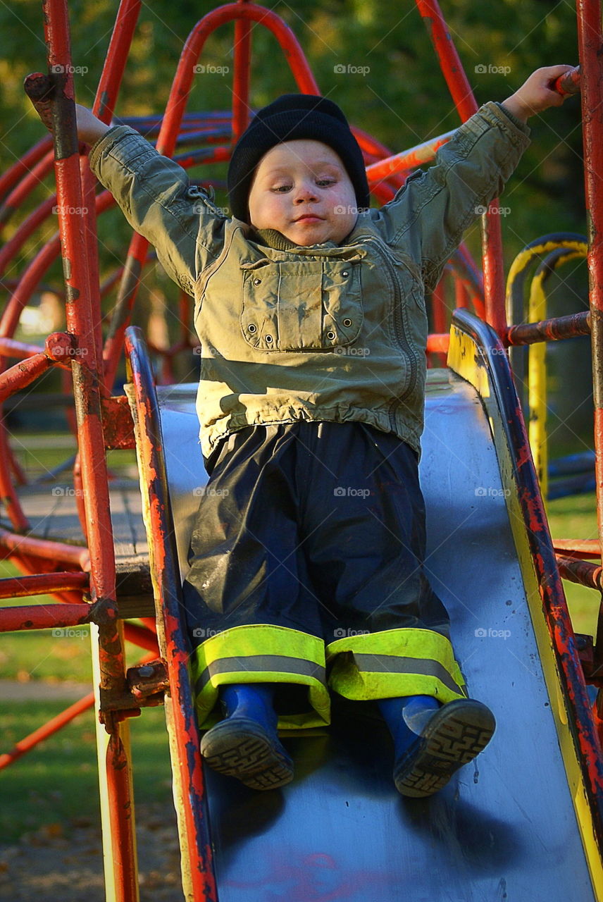 Boy going down the slide