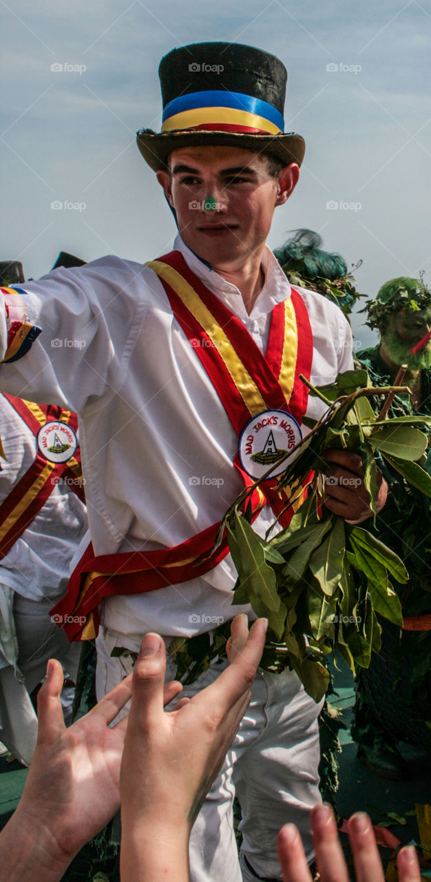 A member of Mad Jack’s Morris, hands out parts of the slain Jack as good luck tokens, at Hastings Traditional Jack in the Green, U.K. 2008