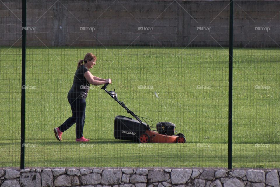 woman cutting grass