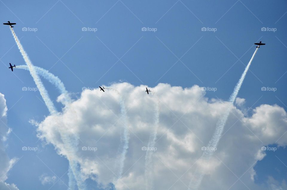 Fluffy white clouds with jets flying by them