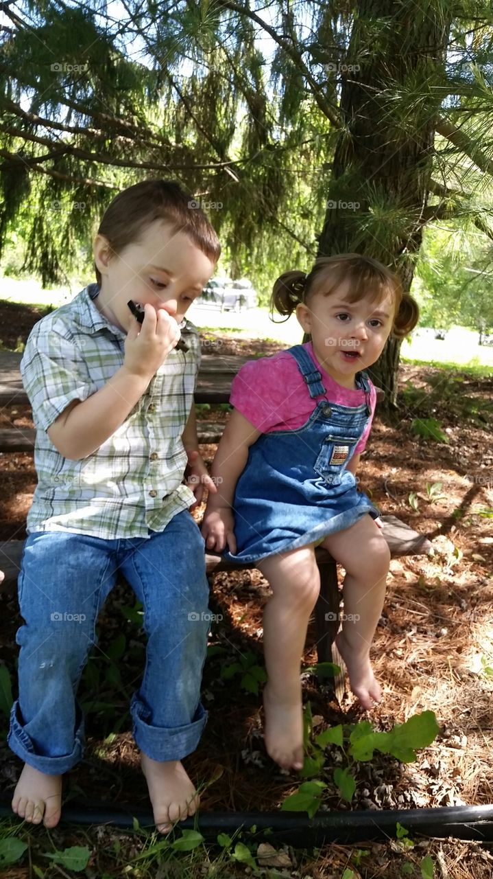 bro plays harmonica while sis sings. they're a little bit country 