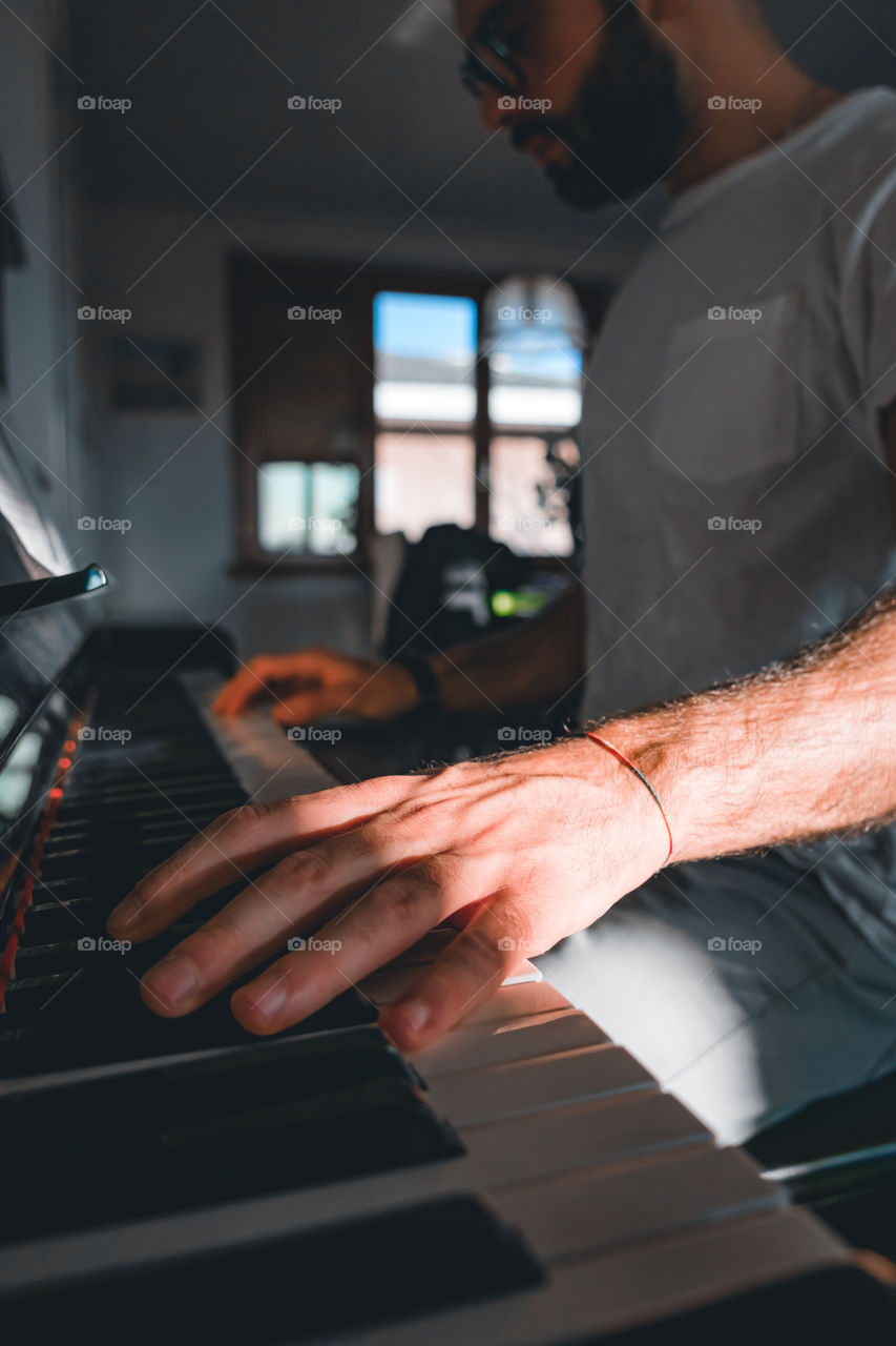 Hands playing a piano