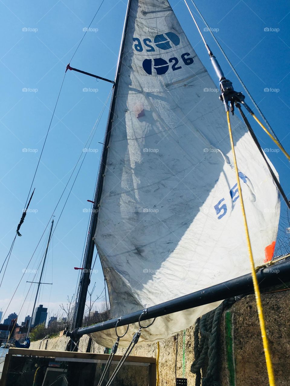 The hoisted sail of our boat the “Salvation” seen from the other side on a beautiful clear summertime afternoon with the bluest skies possible. September 2017. Hypnotic Productions