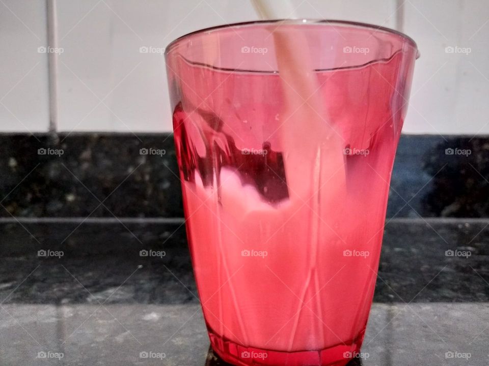 milk in red glass cup