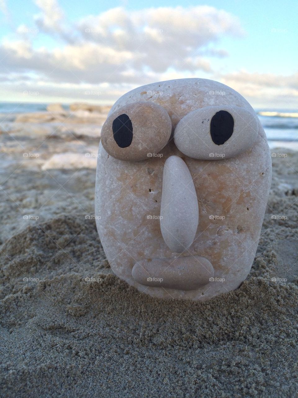 Stone face on the beach