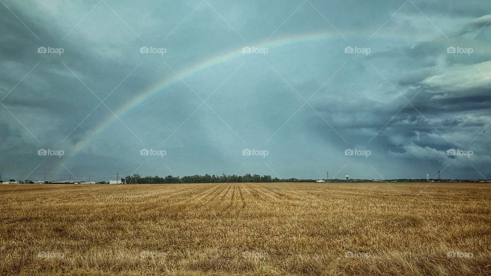 Rainbow over a harvested wheat field in Kansas