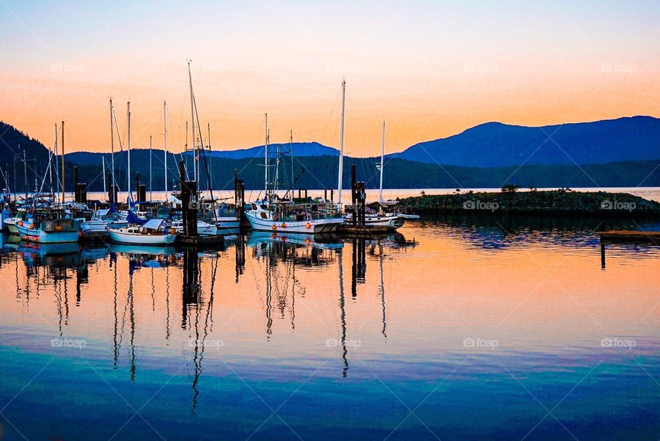 Colourful ocean bay with sailboats and mountains 