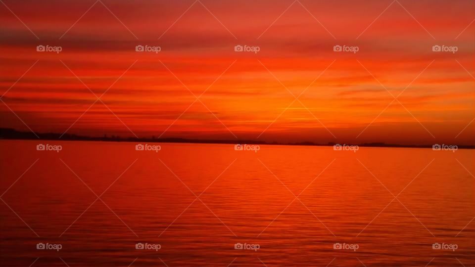 Where does the sky begin and end? Nature without filter. Sunset on Lake Guaíba - Porto Alegre - Brazil.