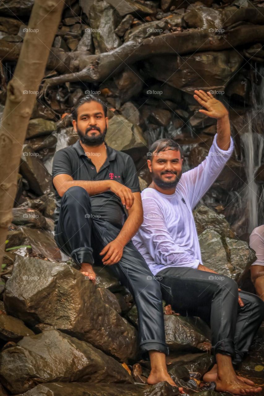 Friends enjoying waterfall