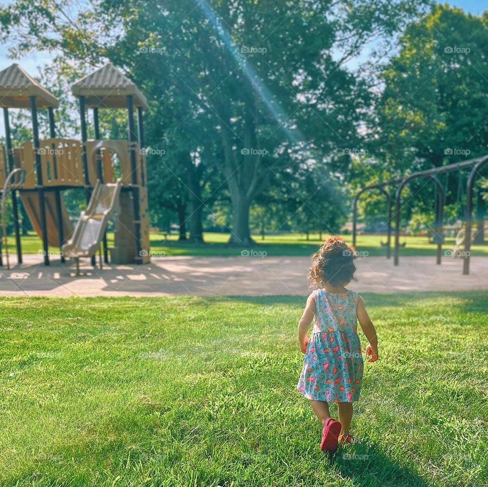 Summertime outfits, summer dress on toddler girl, toddler walking onto playground, toddler at the park