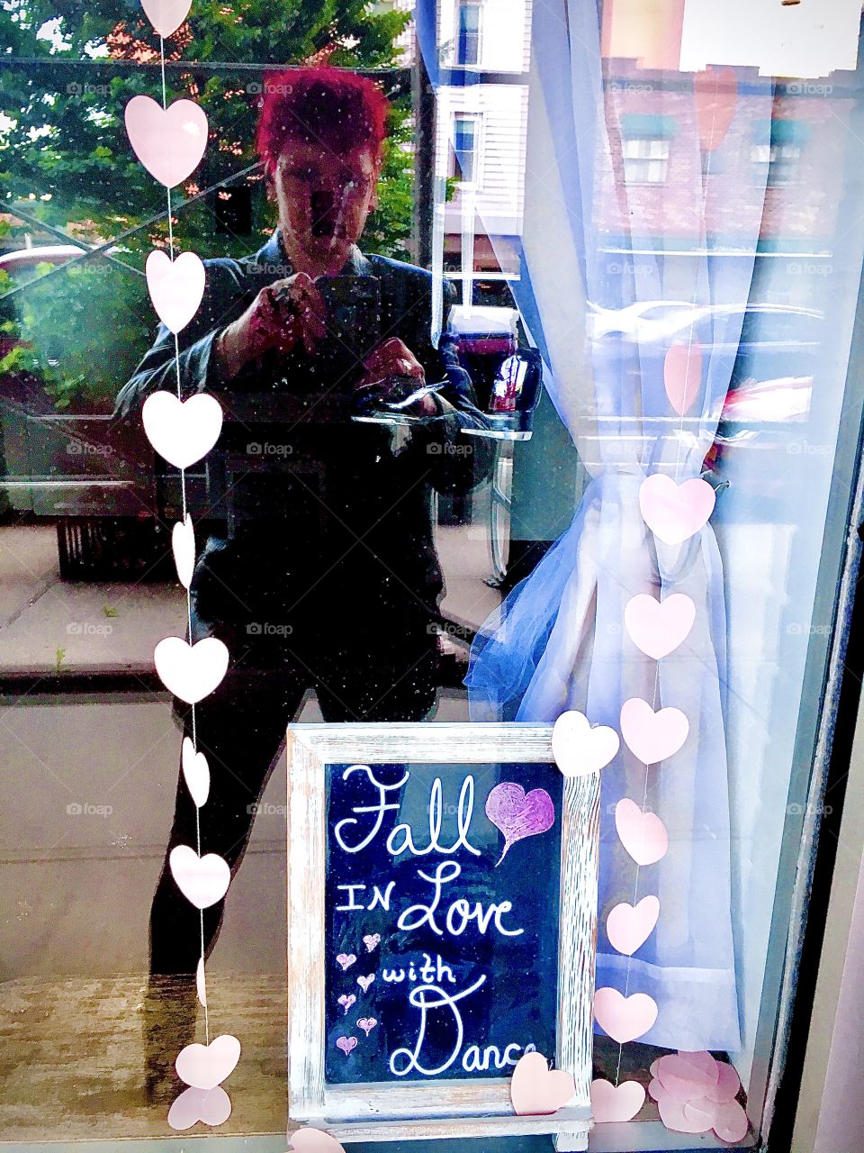 A storefront window in Long Island City, Queens, NY and sign „Fall in love with Dance“. Again I am reflecting in the glass while taking the picture. Spring 2020. Hypnotic Productions