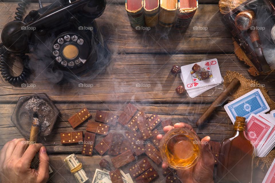 retro game table, smoke, bets, dollars, pipe, retro phone, dominoes, dice, vice, habits, bad habits, cigar, good life, alcoholic, alcohol, distilled