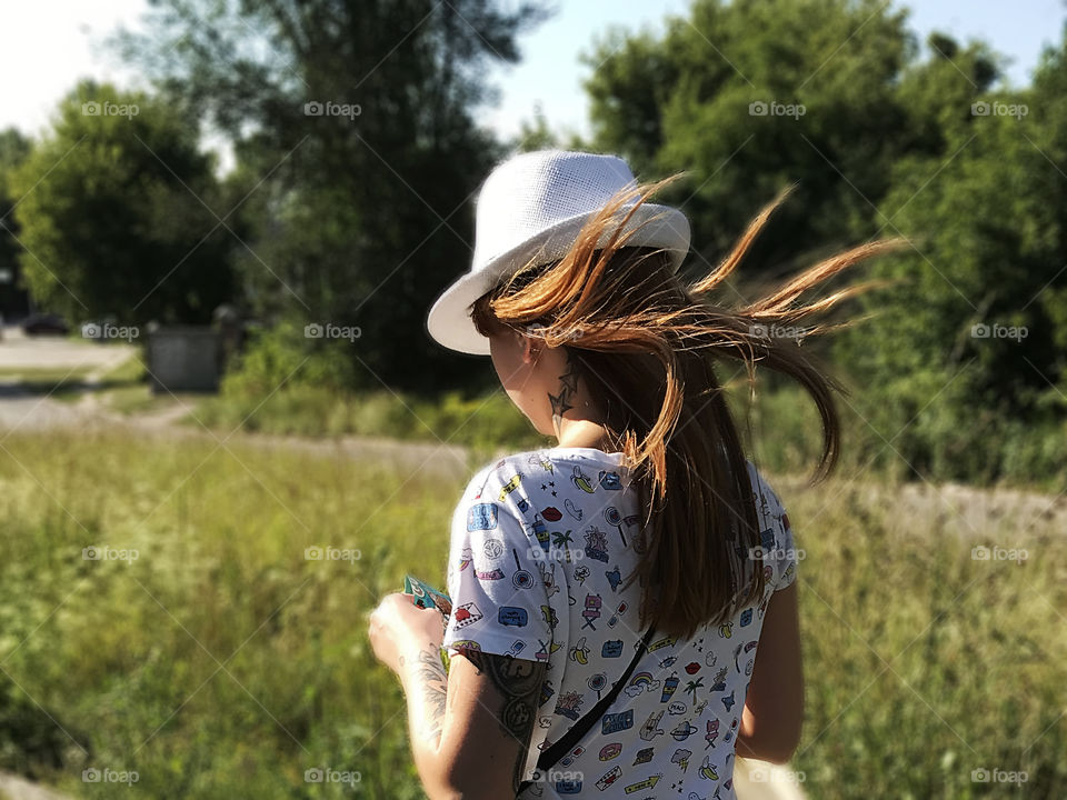 Enjoying the last summer days walking in the city park 