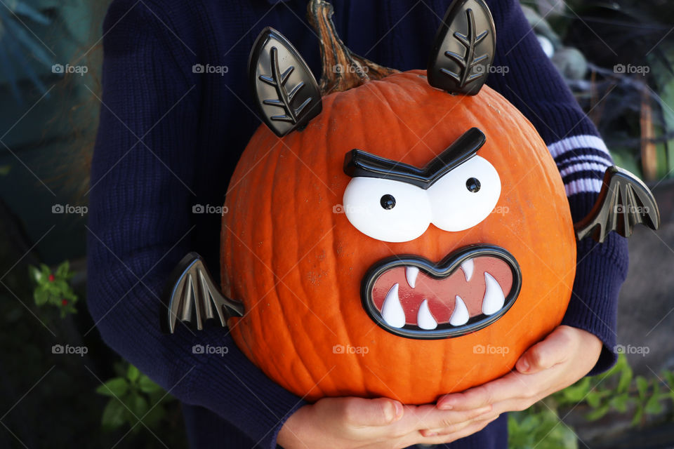 Child holding its pumpkin