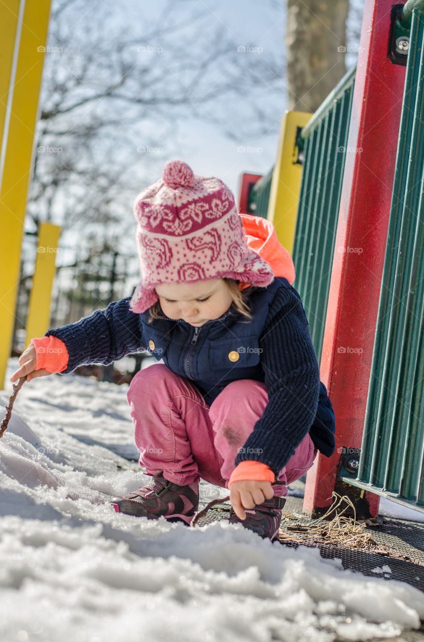 Toddler playing in the snow